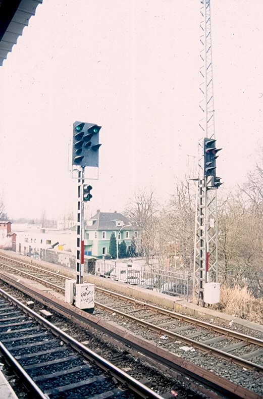 Das Einzige, mir bekannte Signal, welches mit 2 verschiedenen Eisenbahn - Signalsystemen gearbeitet hat. In Hamburg - Eidelstedt fand sich dieses kuriose Einzelstck weil hier die Hamburger S-Bahn mit Sv-Signalen (Signalverbindungen) und die AKN mit Hp-Signalbgriffen fhrt. Hier: Sv1 (Fahrt/Fahrt erwarten) in Verbindung mit Zp9 als Fahrtbegriff fr die Hamburger S-Bahn Richtung Pinneberg. In diesem Ampel-hnlichen Anbau befindet sich neben dem Zp9 noch das Zp10 (Tren schlieen). Inzwischen hat hier auch die ESTW-Technik zugeschlagen und es befindet sich hier ein KS-Signal. Hinweis: eigescanntes Dia