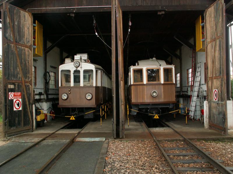 Der 4achser TW 105  Alioth  Nesseldorfer Waggonbaufabrik Basel(1910) links und der 2achser Nr.12 Grazer Waggonfabrik AG (1907) rechts,im Schuppen von Oberbozen am 23.10.05