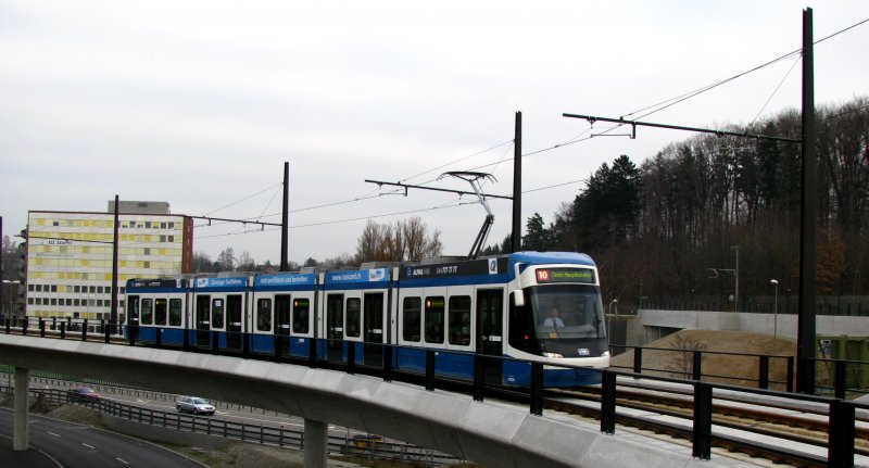 Der Be 5/6 3054 im klassischen VBZ-Design legt sich auf dem Viadukt Balsberg in die Kurve. Dieser Viadukt ist rund 860 Meter lang, fhrt vom Glattbrugger Quartier Unterriet bis kurz vor die Verkehrsdrehscheibe Zrich Flughafen und beinhaltet die Haltestelle Bahnhof Kloten Balsberg. Hier kann man ber eine Fussgngerpassarelle zum verlngerten Perron der S7 gelangen. Weiter fhren mehrere Treppen und Aufzge aufs Strassenniveau zu den Bushaltestellen. 28. Dezember 2008