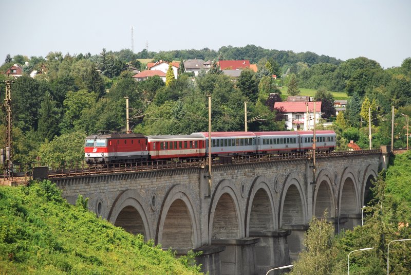 Die 1144 272 passierte am 18. August 2009 das Viadukt zwischen den Haltstellen Neulengbach und Neulengbach Stadt. Am Zughaken hatte sie eine fr einen Regionalexpress auergewhliche Garnitur. Es war der REX 3293 TIERGARTEN SCHNBRUNN von Kleinreifling nach Wien West.
