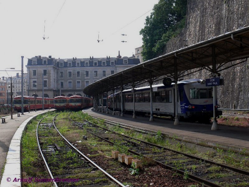 Die Bahnsteigseite des Bahnhofs Lyon Saint-Paul: Pure Eisenbahnromantik - mitten in der zweitwichtigsten Stadt Frankreichs.
Auf allen Gleisen sind hier EAD (Caravelle) Dieseltriebzge zu sehen.
Auch wenn die Strecke zum Bahnhof elektrifiziert ist und direkt hinter dem Bahnhof steil ansteigend in einem Tunnel verschwindet, fahren hier nur diese betagten Dieseltriebzge. Die Zge stehen alle mit den Steuerwagen nach oben und werden also hochgeschoben. Von links nach rechts zu sehen sind hier die XR8688, XR8698, XR8725, sowie auf dem rechten Gleis die XR8435+XR8729.
09.06.2007  Lyon Saint-Paul