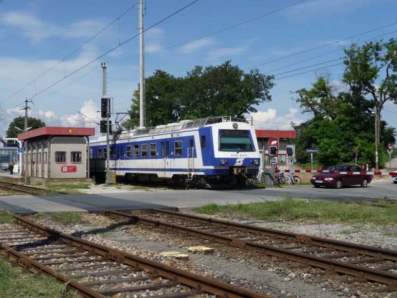 Die Doppelgarnitur 4020 224-4 + 4020 213-7 verlsst gerade die Bahnhaltestelle Gerasdorf und berquert den Elfingerweg. (07.07.09)