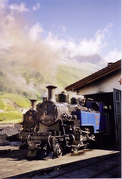 Die Loks HG ¾ 1 Furkahorn und HG ¾ 9 Gletschhorn der Dampfbahn Furka-Bergstrecke (Meterspur Adhsions- und Zahnradbahn), vor dem Depot in Realp 1538m, im Juli 2006.

