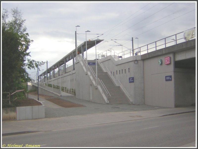 Die neue S-Bahn-Station in Frankfurt am Main-Zeilsheim am 11.05.2007 aufgenommen, zwei Tage vor der offiziellen Inbetriebnahme. Deutlich erkennbar die großzügig ausgelegte Auffahrtrampe, die Behinderten, Eltern mit Kinderwagen sowie Fahrgästen mit Fahrrädern einen bequemen Zugang zum Bahnsteig ermöglicht.