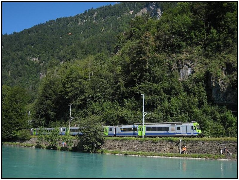 Die Strecke zwischen den Bahnhfen Interlaken-West und -Ost fhrt zu einem guten Teil entlang der Aare. Am frhen Vormittag des 25.07.2008 habe ich vom Ufer gegenber diesen BLS-Regionalzug RBDe 565 aufgenommen, der zwischen Spiez und Interlaken-Ost pendelt.