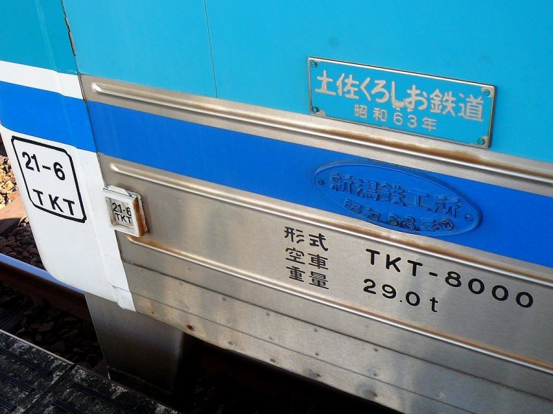 Die Tosa Kuroshio-Bahn (Westabschnitt), Triebwagen 8002 - ein Blick auf seine Anschriften. Zuoberst (hellblau) ist der Eigentmer angegeben:  Tosa Kuroshio Tetsud (Tetsud = Eisenbahn), bernommen im Jahr 63 des Kaisers Shwa (=1988) . Darunter (dunkelblau) die Tafel des Erbauers:  Niigata Eisengiesserei, Jahr 63 des Kaisers Shwa (=1988) . Darunter die Typenangabe  TKT - 8000  (also Tosa Kuroshio-Bahn Typ 8000), Leergewicht 29,0 t. Am Wagenende steht die Angabe der letzten Hauptuntersuchung:  Jahr 21 des Kaisers Heisei (=2009), 6. Monat, berholt durch TKT .  