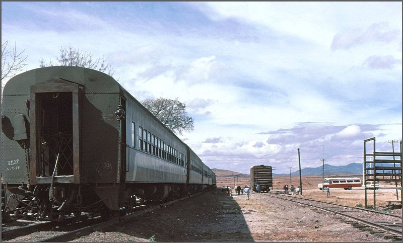 Einsamer Bahnhof im zentralen Hochland Mexicos mit Busanschluss und Viehverladerampe. Der Wagen der Primera classe am Zugschluss hatte eine Art offene Plattform gesichert mit einem Scherengitter. Dort hielten wir uns fast immer auf whrend der zwlfstndigen Fahrt von Mexico City nach Patzcuaro.(Archiv 02/77)