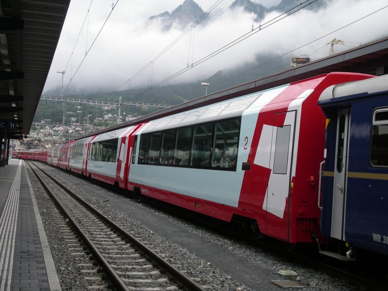 Glacier Express 907 wird nach Ankunft von St.Moritz mit Glacier Express 905 gekuppelt. Die Lok und die ersten sieben Wagen des angekommenen Zuges bleiben in Chur. Trotz trben Wetters an diesem 08.07.2006 sind die 15 Wagen des Glacier Express nach Zermatt praktisch voll besetzt.