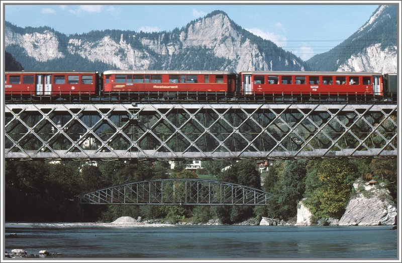 Glacier Express mit BVZ Wagen, RhB Speisewagen und FO Wagen auf der Hinterrheinbrcke bei Reichenau-Tamins. Die Strassenbrcke im Hintergrund ist lngst durch eine gesichtslose Betonbrcke ersetzt worden. (Archiv 09/78)
