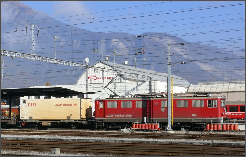 Gterzug mit Ge 6/6 II 704  Davos  steht abfahrbereit in Landquart. Rechts ber dem Fahrleitungstrenner sieht man den Fadrastein, einen einmaligen Aussichtspunkt mit Blick ber das ganze Churer Rheintal. (01.11.2007)