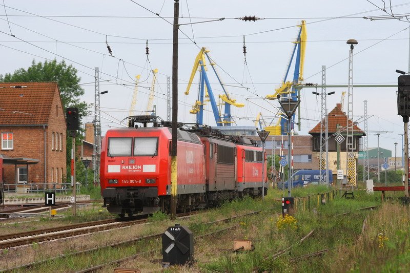 Im Bahnhof Wismar stehen 145 004, 155 065 und 140 528. Im Hintergrund Stellwerk W2 und die Krane vom Seehafen. 19.06.2007