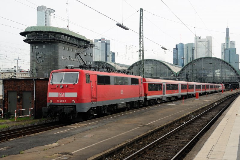Im Sandwich wird die ber-Regionalbahn (Bayern-Hessen), untersttzt durch 111 209-3, in den Kopfbahnhof von Frankfurt gedrckt. Das charakteristische Stellwerk im Hbf blickt erhaben auf die  Pumas  herab. (April 2009).