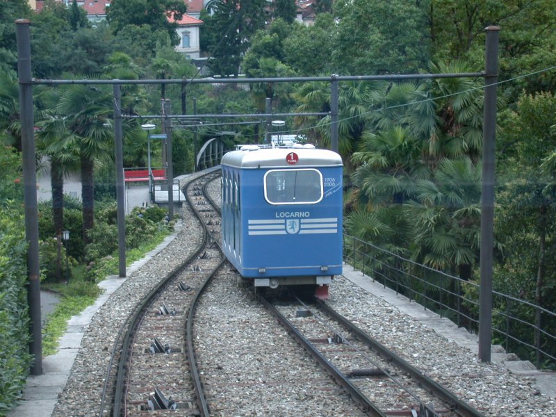In Streckenmitte kreuzen wir inmitten von Palmen den Wagen 1 der FLMS, der talwrts Richtung Locarno fhrt. (05.08.2006)