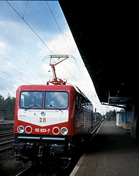 Kurz nach der Auslieferung: 112 023-7 noch mit DR-Emblem. Aufgenommen 1993 im oberen Teil des ehem. Potsdamer Hauptbahnhofs am Berliner Aussenring. Der Bahnhof heit heute Pirschheide und hier oben hlt schon seit etlichen Jahren kein Personenzug mehr. Leider ist dieser Nachschuss etwas unscharf, aber das gute Stck hat mich etwas berrascht. Hinweis: eingescanntes Dia