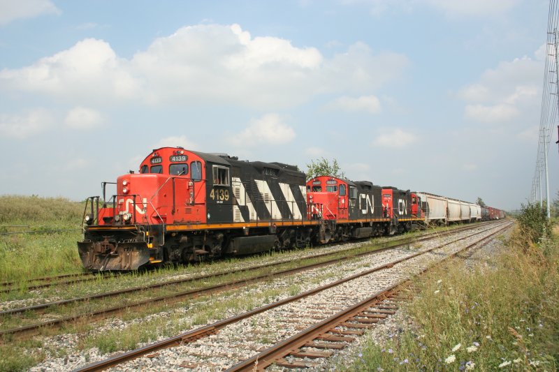 Kurzgterzug mit drei CN GP9RM 4139 (ex.CN 4287), 7027 und 7022 beim Rangieren, um ein Industriegleis zu bedienen. Diesmal von der anderen Strassenseite.am Torbram Road in Toronto,20.8.2009.
