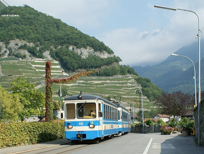 Mitten auf der Strasse in Aigle trifft man immer noch auf die Zge von ASD und AL. Hier der Regionalzug 453 von Les Diablerets. Doch der Grund fr die Aufnahme war der vollkommen mit wildem Wein berwucherte Fahrleitungsmast.
(23.09.2008)
