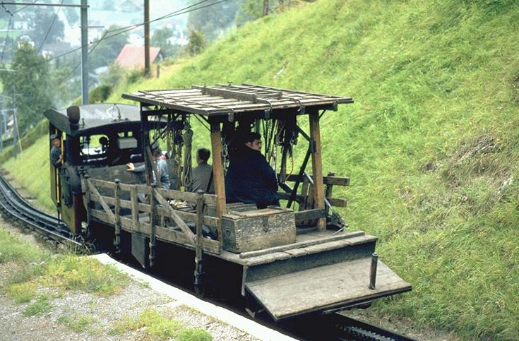 Pilatus Bahn (PB)Zahraddampflok No.9 (SLM 1889)mit Arbeitswagen auf Bergfahrt.Das waren die letzten Bilder,(1980)die diese historische Lok nochmals unter Dampf zeigen,die nachher in das Verkehrshaus der Schweiz nach Luzern kam und nun dort zu bewundern ist.(Archiv P.Walter)