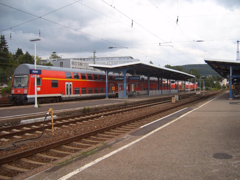 RE 19470 bei der Abfahrt nach Stuttgart Hbf. Den Zug zieht eine unbekannte BR 143. Gesehen am 21.08.06 im Bahnhof Aalen. Heute sieht man die DR-Dostos merkwrdigerweise nicht mehr. Was da passiert ist, wei ich nicht. Im Moment bedienen die stinknormalen EX-Silberlinge die Remsbahn nach Stuttgart. 