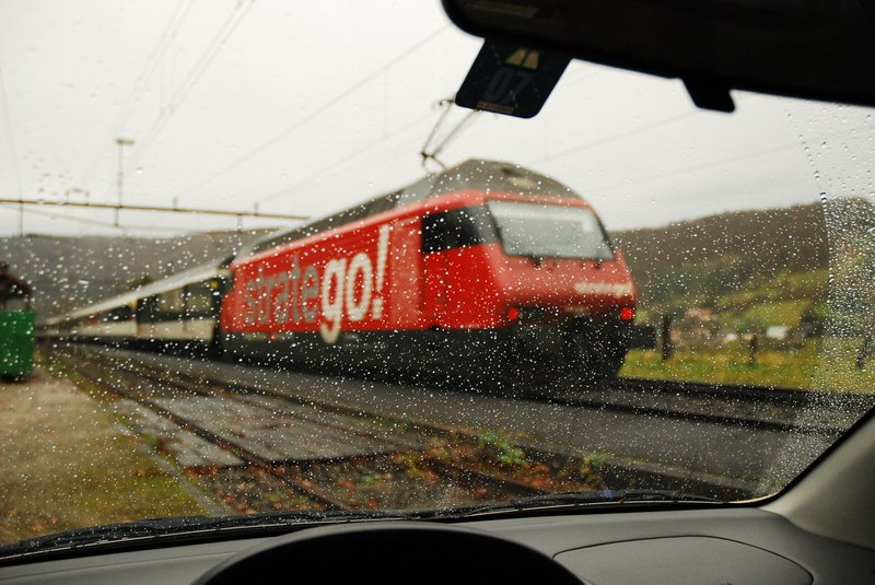 Re 460 038-3. Wer sagt denn, da man im Regen nicht fotografieren kann ? Man bleibt bequem im Auto sitzen und drckt nur auf den Auslser. Dabei kann man entscheiden, ob mit oder ohne Regentropfen auf der Frontscheibe und ob mit oder ohne Fensterrahmen im Bild. Im Fricktal (Kanton Aargau) am 4.12.2006