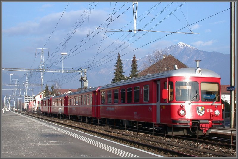 Regionalzug nach Thusis hlt in Domat/Ems. Be 4/4 516 und Steuerwagen 1716. Im Hintergrund leuchtet der schneebedeckte 2266m hohe Montalin oberhalb Churs. (01.02.2007)