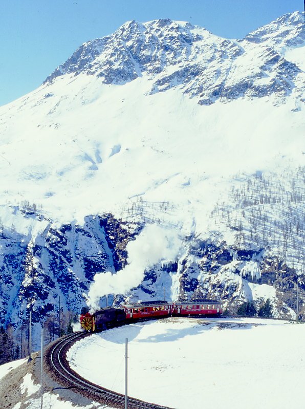 RhB Dampfschneeschleuder-Extrazug fr GRAUBNDEN TOURS 9448 von Cavaglia nach Alp Grm am 28.02.1998 in der Einfahrtskurve Alp Grm mit Dampfschneeschleuder X d rot 9213 - Triebwagen ABe 4/4I 30 - ABe 4/4 I 34. Hinweis: gescanntes Dia
