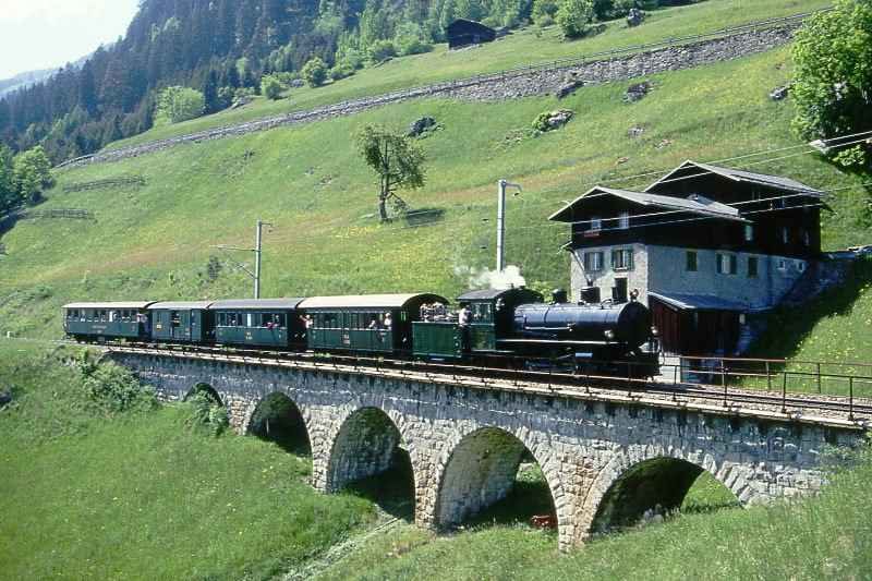 RhB Dampfzug 3262 fr GRAUBNDEN TOURS von Disentis nach Landquart am 23.05.1998 auf Bach da Cauns-Viadukt bei Compadilas mit Dampflok G 4/5 107 - A 1102 - B 2060 - D 4052I - B 2245. Hinweis: gescanntes Dia

