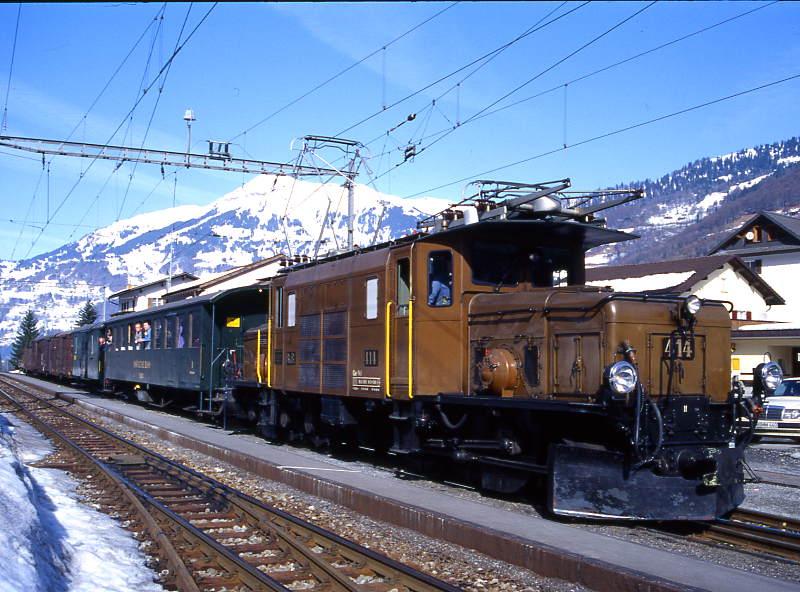 RhB Extra-GmP fr GRAUBNDEN TOURS AG 3031 von Landquart nach Davos-Platz vom 14.03.1999 in Schiers mit E-Lok Ge 6/6I 414 - B 2246 - D 4052II - Gbkv 5568 - Gbkv 5593 - Gb 5082 - E 6610 - Kk 7070. 