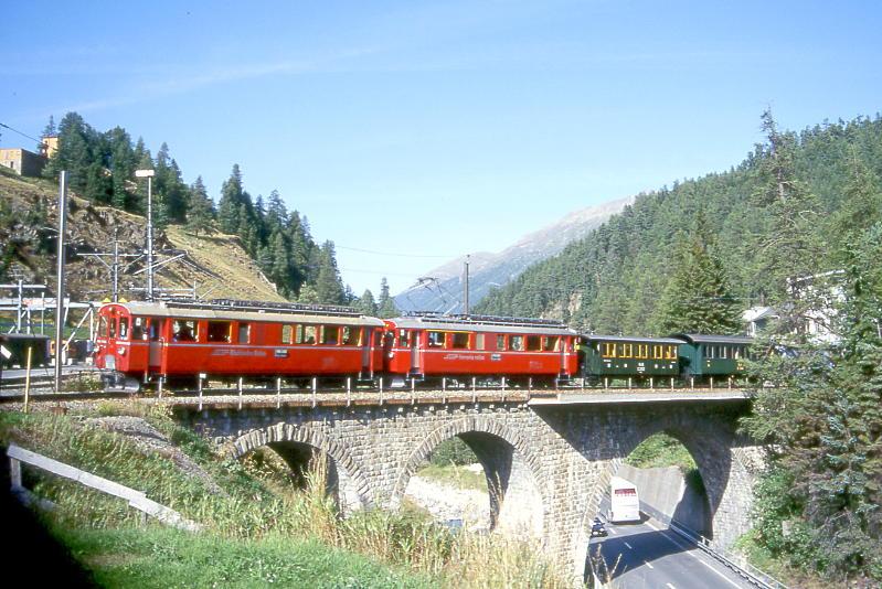 RhB EXTRAZUG 3472 von Ospizio Bernina nach St.Moritz am 26.08.2000 auf Innviadukt Einfahrt St. Moritz mit Triebwagen ABe 4/4I 30 - ABe 4/4I 34 - C 2012 - B 2060 - Xk 9398 - G 3/4 1. Hinweis: Die beiden Triebwagen sind inzwischen in gelb umlackiert!
