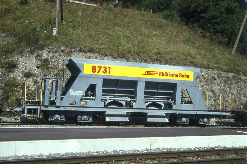 RhB - Fad 8731 am 01.09.1993 in Tiefencastel - Selbstentlade-Schotterwagen 4-achsig mit 1 offenen Plattform - bernahme 01.07.1993 - JMR - Gewicht 15,13t - Zuladung 33,00t - LP 12,50m - zulssige Geschwindigkeit 80/B km/h - Probelackierung Logo RhB in deutsch auf gelben Untergrund - Lebenslauf: ex Fad 8731 - 02/2004 Fac 8731.
