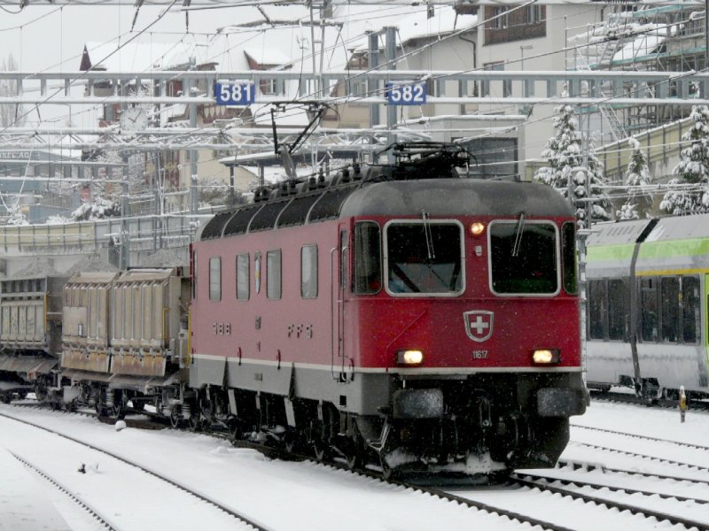 SBB - Re 6/6 11617 vor Gterzug bei der einfahrt in den Bahnhof von Spiez am 12.12.2008