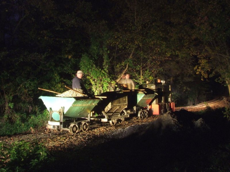 The volunteers working in the night. The engine and the bogies are museum pieces.