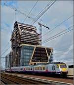 Am Bahnhof in Hasselt entsteht ein sehr eigenwilliges Hochhaus, whrend die AM80 333 am 11.03.2011 daran vorbeifhrt.