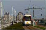 - Tiefstehende Sonne - De Kusttram hat soeben die Haltestelle Oostende Station verlassen und fhrt durch die Leopold II-laan vor der Kulisse des Jachthafens und des schnen Bahnhofs von Oostende in Richtung De Panne. 12.11.2011 (Jeanny)