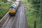 Die Class 66 DE6309 von Crossrail kommt mit einem gemischten Containerzug von Aachen-West und fhrt gleich in den Gemmenicher Tunnel rein bei Regenwetter.