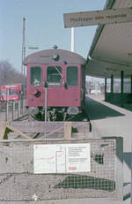 DSB  Hareskovbanen  (København L - Farum): Am 24. April 1976 steht u.a. ein Steuerwagen des Typs Cls im Bahnhof København L (= Lygten). Auf dem Schild steht - man könnte es fast symbolisch auffassen - dass der Zug keine Fahrgäste mitnimmt. An diesem Tag gab es nämlich zum letzten Mal Bahnbedienung dieses Bahnhofs; darüber berichtet die Tafel im Vordergrund. Ab dem 25. April 1976 sollten die Dieseltriebzüge der  Hareskovbanen  stattdessem im S-Bahnhof Svanemøllen enden. - Der  Hareskov  ist ein Wald (skov: Wald) in der Nähe von Farum, durch den die Bahn fährt. - Die Straße, an welcher der Bahnhof lag, heißt  Lygten , ein Name, der mit dem ehemaligen Bach  Lygteåen  zusammenhängt. Die Silbe 'lyg(t)' hieß im altdänischen 'løgh', ein Wort, das 'sump', dt. 'Sumpf', bedeutete. - Scan eines Farbnegativs. Film: Kodak Kodacolor II. Kamera: Minolta SRT-101.