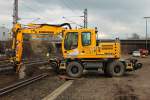Ein Liebherr 900 Zweiwegebagger von THG verarbeitet am 06.03.2012 neues Material in dem vorher ausgekofferten Gleisbett an der KBS 480 in Aachen Rothe-Erde.