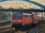 111 114 schiebt den RE4 am 29.11.2011 im Zickzack-Kurs unter der Burtscheider Brcke aus Aachen Hbf.