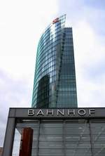 Hinter dem Eingang zum Bahnhof Berlin Potsdamer Platz erhebt sich der 103 m hohe Bahntower, die Zentrale der Deutschen Bahn.