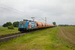 HSL 186 381 mit einem Getreidezug am 24.05.2023 zwischen Landesbergen und Estorf (Weser) auf der Natobahn.