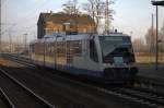 Ein TW der Ruhtalbahn taucht in die aufgehende Dezembersonnne am  Bahnhof  Lutherstadt Wittenberg ein.