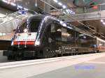 Die von DB Fernverkehr AG angemietete ES 64 U2-074 alias 9180 6 182 574-4 D-DISPO an einem EuroCity nach Stralsund im Tiefbahnhof von Berlin.(07.02.2010)