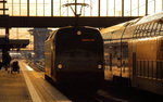 Im goldenen Abendlicht verlässt 183 001, die auf das Jubiläum  175 Jahre Deutsche Eisenbahn  aufmerksam macht, den Münchner Hauptbahnhof, nachdem sie den ALX 352 (Praha hl.n -