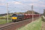 Eine schwarze MRCE Class 66 (653-09) mit einem langen Ganzzug Selbstentladewagen der OHE in Magdeburg Diesdorf. Die Fahrt ging in Richtung Braunschweig. Fotografiert am 22.04.2010. 