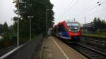 Zwei Euregiobahn (RB20) aus Heerlen(NL)-Stolberg-Altstadt-Düren kommt die Kohlscheider-Rampe hoch aus Richtung Herzogenrath und hält in Kohlscheid und fährt in Richtung Richterich,Laurensberg,Aachen-West.
Bei Regenwetter am Morgen vom 8.7.2014.