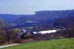 194 584 schiebt einen Zug die Spessartrampe bei Hain hinuf, 17.04.1987.