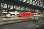 403 026 wartet am Bahnsteig, whrend 101 096 auf dem Nebengleis duch den Bahnhof rollt.