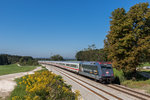 101 004 macht seit kurzem Werbung für die  Bahn BKK  und schiebt hier einen EC durchs Chiemgau in Richtung München, aufgenommen am 8. September 2016.