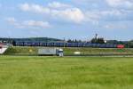 Blauer Lindwurm mit rotem  i-Tpfelchen  vor der malerischen Kulisse von Scheppach. Im Vordergrund die A8 Ulm - Augsburg. Aufgenommen am 21.06.2011 .