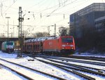 185 297-9 von Railion kommt bei Schnee und Sonne mit einem Autozug aus Richtung Kln und fhrt in Aachen-West ein am 5.2.2012.
