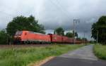 185 002-3 fuhr am 02.06.2012 mit einem Gterzug von Emden nach Osnabrck, hier kurz vor Leer.